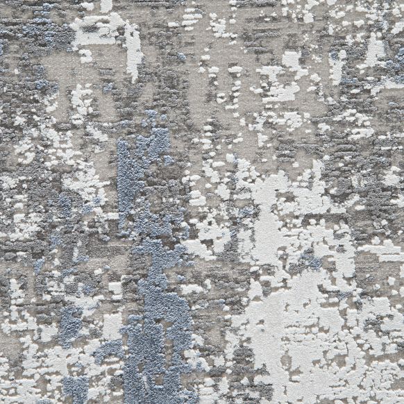 Strukturierte Teppichoberfläche mit unregelmäßigem Muster in Blau, Weiß und Grau.