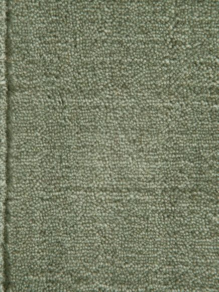 grüner teppich mit dichter textur und geketteltem rand, draufsicht