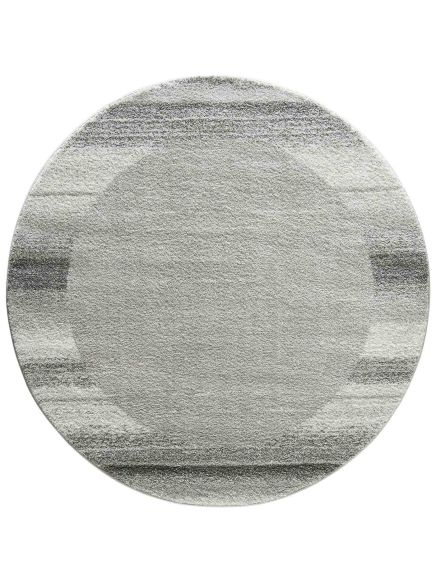 Runder Teppich mit grauem Farbverlauf und geometrischem Muster auf hellem Hintergrund.