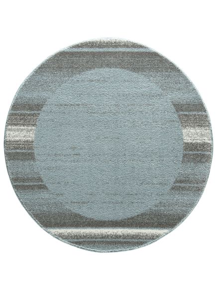 Runder Teppich zeigt blauen Kreis in der Mitte, umgeben von grauen und weißen Streifen.