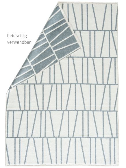 Teppich zeigt lineares Muster in zwei Farbkombinationen, eine Ecke umgeschlagen, beidseitig verwendbar.