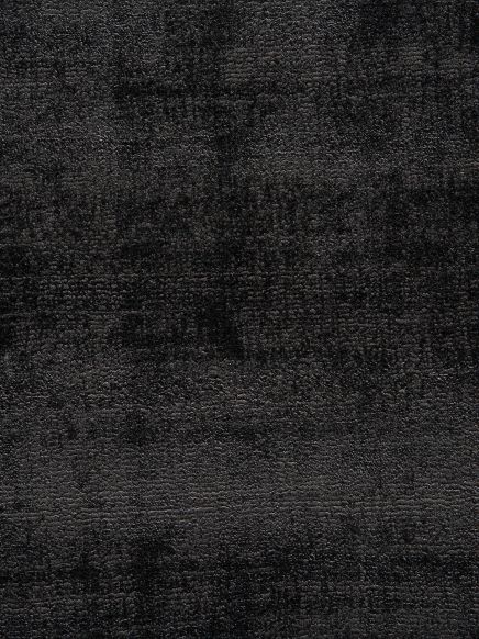 Texturierte Teppichoberfläche zeigt ein gleichmäßiges dunkles Muster in einem Innenraum.