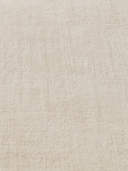 Hellbeige strukturierte Oberfläche mit weichem, texturiertem Muster in gleichmäßiger Verteilung.