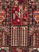 Teppich zeigt geometrische Muster und florale Motive in Rot, Blau und Beige.