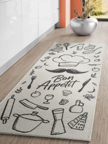 Teppich mit Küchengrafiken, Text "Bon Appétit", liegt auf Holzboden in moderner Küche